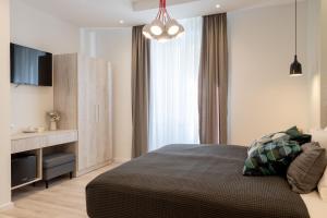 a bedroom with a bed with a television and a cabinet at Sweet Dreams-Old Town in Split
