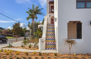 a building with a colorful staircase next to a street at La Playa Inn Santa Barbara in Santa Barbara