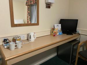 a desk with a laptop computer on it at Days Inn Michaelwood M5 in Falfield