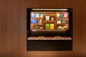 a window in a wall with a shelf with books at Crowne Plaza Paris République, an IHG Hotel in Paris