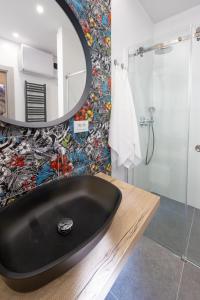 a bathroom with a black sink and a mirror at Sweet Dreams-Old Town in Split