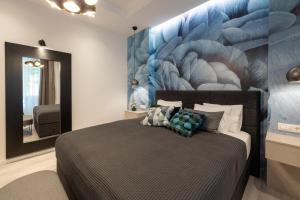 a bedroom with a bed and a large painting on the wall at Sweet Dreams-Old Town in Split
