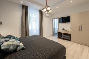 a bedroom with a bed and a flat screen tv at Sweet Dreams-Old Town in Split