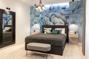 a bedroom with a bed and a wall mural at Sweet Dreams-Old Town in Split