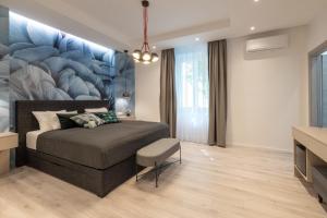 a bedroom with a bed with a large painting on the wall at Sweet Dreams-Old Town in Split