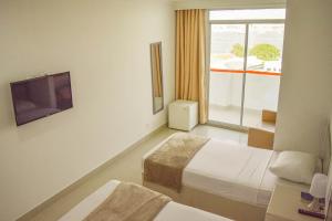 Postel nebo postele na pokoji v ubytování Hotel Cartagena Premium