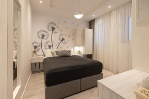a bedroom with a bed with dandelions on the wall at Sweet Dreams-Old Town in Split