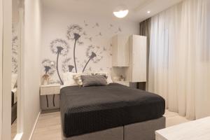 a bedroom with a bed with dandelions on the wall at Sweet Dreams-Old Town in Split