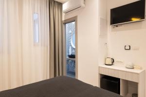 a bedroom with a bed and a tv and a fireplace at Sweet Dreams-Old Town in Split