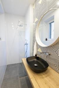 a bathroom with a black sink and a mirror at Sweet Dreams-Old Town in Split