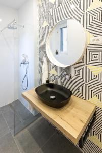 a bathroom with a black sink and a mirror at Sweet Dreams-Old Town in Split