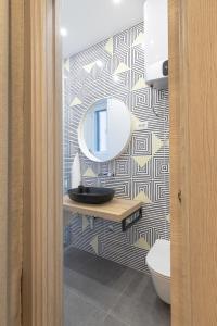 a bathroom with a sink and a mirror on a wall at Sweet Dreams-Old Town in Split