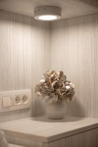 a white vase with a flower in a room at Sweet Dreams-Old Town in Split