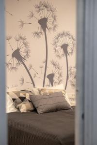 a bedroom with a bed with a dandelion wall mural at Sweet Dreams-Old Town in Split