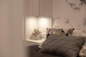 a bedroom with a bed and a vase of flowers at Sweet Dreams-Old Town in Split