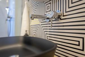 a kitchen sink with a faucet on a wall at Sweet Dreams-Old Town in Split