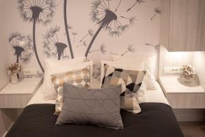 a bedroom with a bed with dandelions on the wall at Sweet Dreams-Old Town in Split