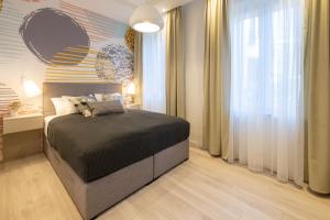 a bedroom with a bed and a large window at Sweet Dreams-Old Town in Split