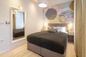 a bedroom with a bed and a large mirror at Sweet Dreams-Old Town in Split
