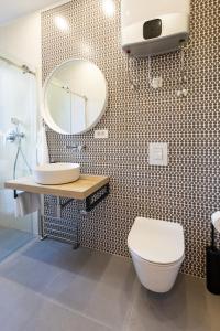 a bathroom with a toilet and a sink and a mirror at Sweet Dreams-Old Town in Split