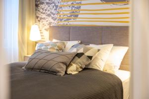 a bed with pillows and an american flag on the wall at Sweet Dreams-Old Town in Split