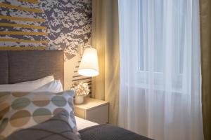a bedroom with a bed and a lamp and a window at Sweet Dreams-Old Town in Split