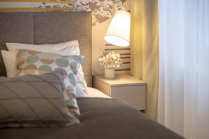 a bedroom with a bed and a lamp on a night stand at Sweet Dreams-Old Town in Split