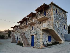 a building with a staircase on the side of it at Stoupa Lefktro 1 in Stoupa