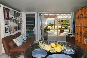 a living room with a table with fruit on it at Chalet Kestrel with pool on the beach in Riambel