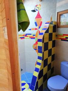 a bathroom with a toilet and a shower curtain at Hospedaje Solentiname in Medellín