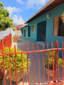 an orange fence in front of a house at Flat Vila dos Milagres in São Miguel dos Milagres