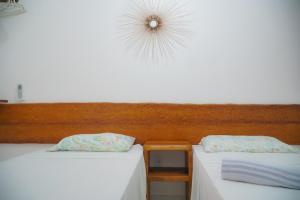 two beds sitting next to each other in a room at Flat Vila dos Milagres in São Miguel dos Milagres