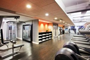 a gym with rows of treadmills and machines at Row NYC at Times Square in New York