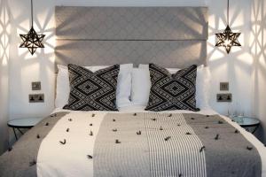 a bedroom with a large bed with two tables at Blackbird Luxury Apartments Room 5 in Blackpool