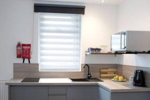 a kitchen with a sink and a window at Blackbird Luxury Apartments Room 5 in Blackpool +9 photos