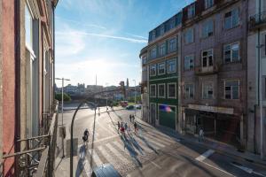 a group of people walking down a city street at Light Blue Apartment in Porto