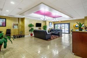 a lobby with couches and a tv in a building at Quality Inn Lakeland North in Lakeland
