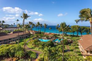 a beach with palm trees and palm trees at Aston Maui Kaanapali Villas in Lahaina