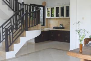a kitchen with a staircase in a house at Bali Dream Resort Ubud in Ubud