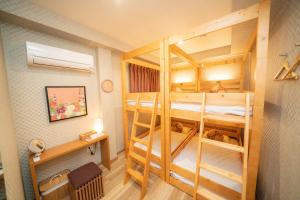 a room with two bunk beds in a room at kaguya asakusa Women only guest house in Tokyo