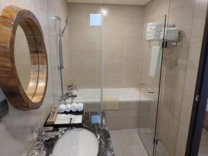 a bathroom with a tub and a sink and a shower at Fu Yuan Tan Villa in Fuyuan