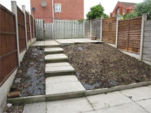 a backyard with a fence and a concrete walkway at Quiet Residential Area Within Easy Reach Of Town in Manchester