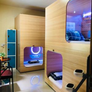a dressing room with a mirror and a suitcase at CapsulePod@Aljunied in Singapore