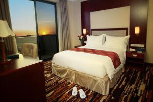 a hotel room with a bed and a large window at Daamat Hotel in Addis Ababa +25 photos