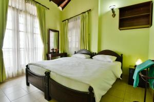 Letto o letti in una camera di Expeditor Kandy