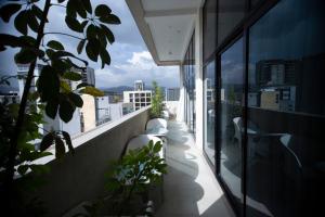 a balcony with plants and a view of a city at Daamat Hotel in Addis Ababa
