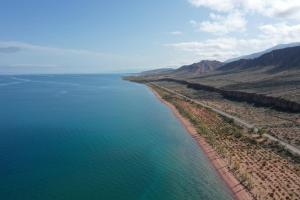 an aerial view of the ocean and a highway at Guest House Guljan in Bokonbayevo