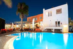 a large swimming pool in front of a building at Valsami Hotel Apartments in Kremasti