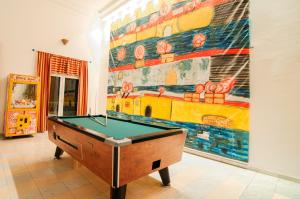 a pool table in a room with a painting on the wall at Valsami Hotel Apartments in Kremasti