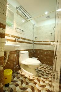 a bathroom with a toilet and a sink at karibu Residency in Malappuram